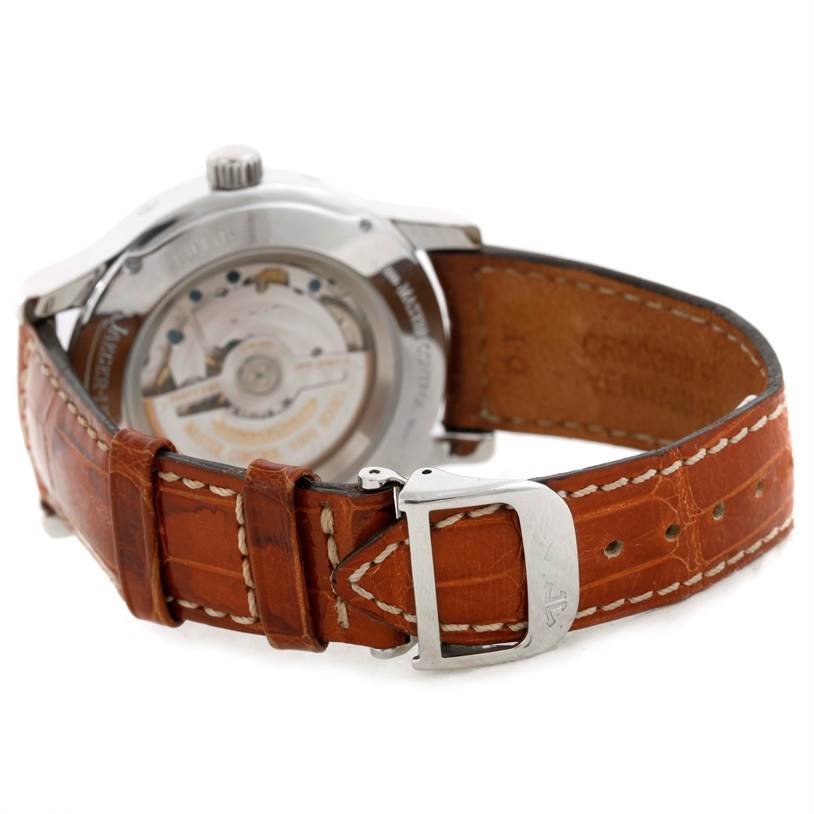 The image shows the back view of a Jaeger-LeCoultre Master model watch, highlighting its movement mechanism and brown leather strap.