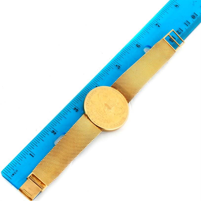 The image shows a Vintage Jaeger LeCoultre watch lying flat alongside a blue ruler for scale, focusing on the band and the face.