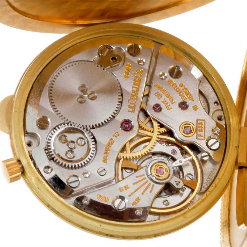 The image shows a close-up of the inner mechanical movement of a Vintage Jaeger LeCoultre watch.