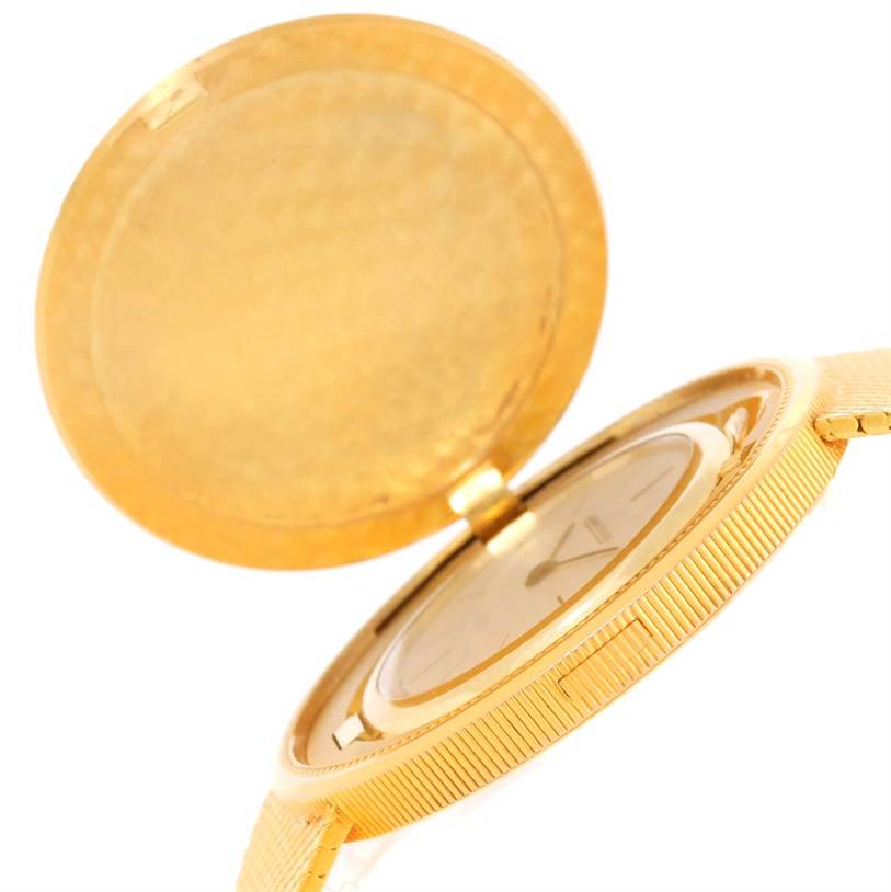 This image shows a partial side angle of a Vintage Jaeger LeCoultre watch with its gold cover open.