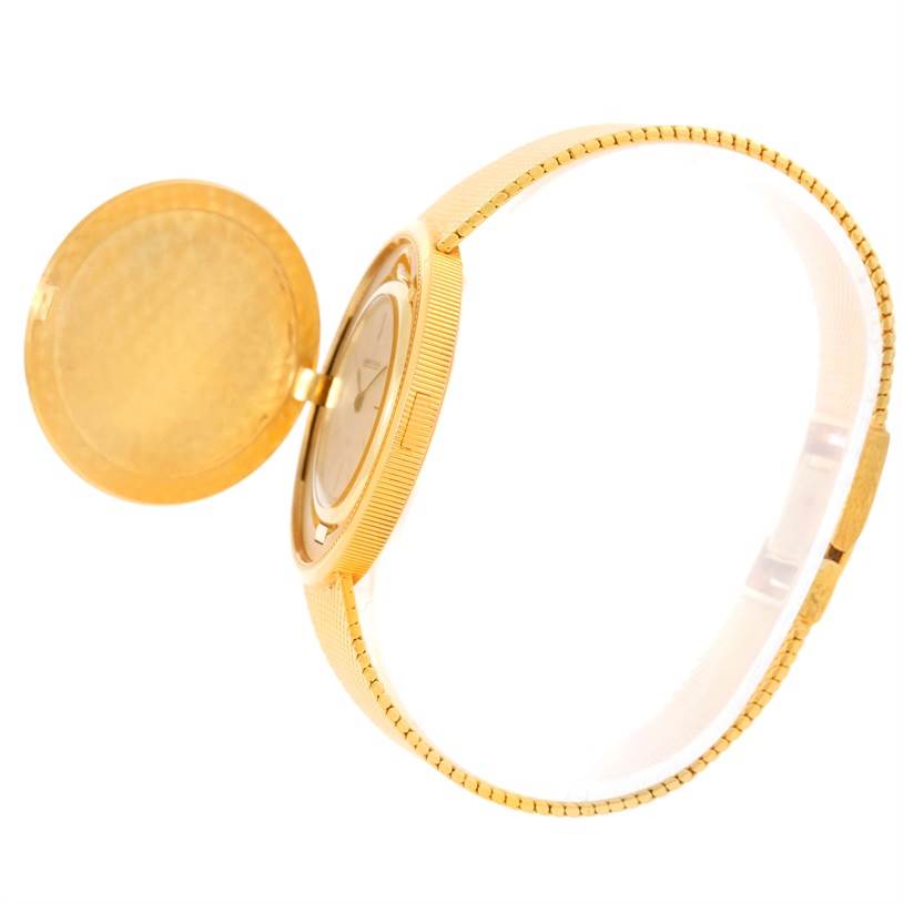 The image shows a side view of a Vintage Jaeger LeCoultre watch with its gold cover open, revealing the watch face and gold band.