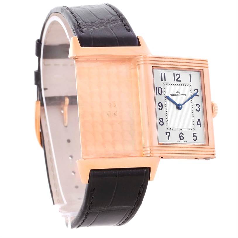 The Jaeger LeCoultre Reverso Q2782520 Men's Rose Gold Silver Dial Q2782520 Men's Rose Gold Silver Dial watch is shown at an angle highlighting both its reversible case and leather strap.