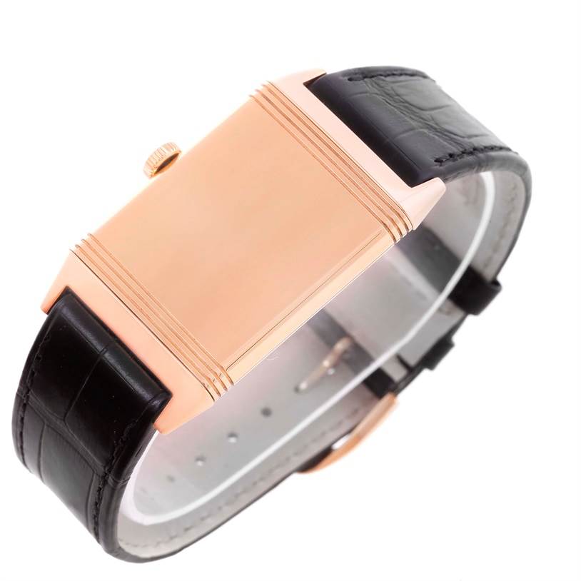 This image shows a side view of a Jaeger LeCoultre Reverso Q2782520 Men's Rose Gold Silver Dial Q2782520 Men's Rose Gold Silver Dial watch, focusing on the case and crown with a partial view of the black leather strap.