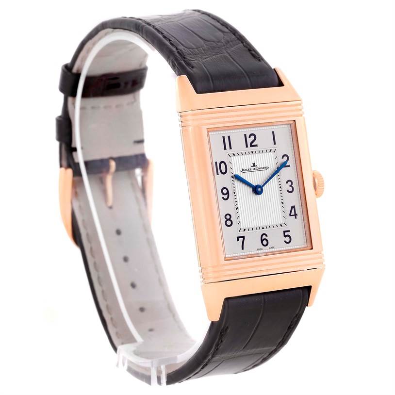 The image shows a Jaeger-LeCoultre Reverso watch at an angled view, displaying the front dial, case, and black leather strap.