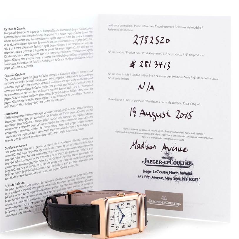 The image shows a Jaeger LeCoultre Reverso Q2782520 Men's Rose Gold Silver Dial Q2782520 Men's Rose Gold Silver Dial watch lying flat with its warranty certificates displayed in the background.