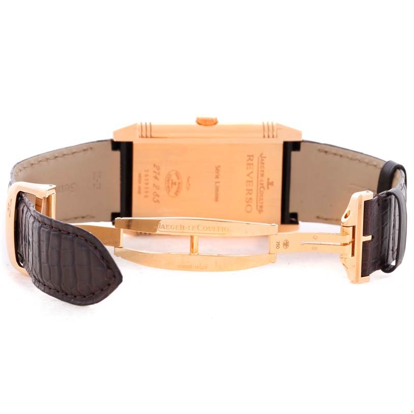 The image shows the back view of the Jaeger-LeCoultre Reverso watch, highlighting the case back, leather strap, and buckle.