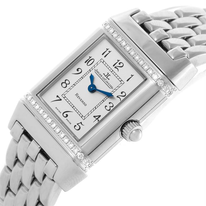 This image shows a close-up, angled view of the Jaeger LeCoultre Reverso 265.8.08 Women's Stainless Steel Silver Dial 265.8.08 Women's Stainless Steel Silver Dial watch face, crown, and part of the metal strap.