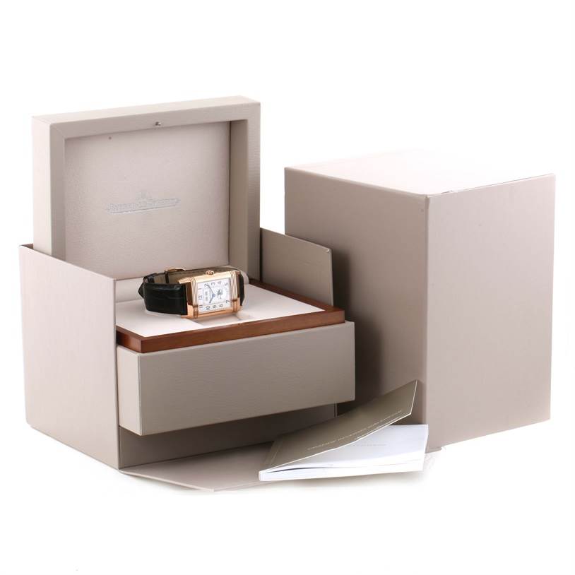The Jaeger LeCoultre Reverso Q3752520 Men's Rose Gold Silver Dial Q3752520 Men's Rose Gold Silver Dial watch is shown in its box, with the box lid open, and the watch's case, strap, and warranty booklet.visible.