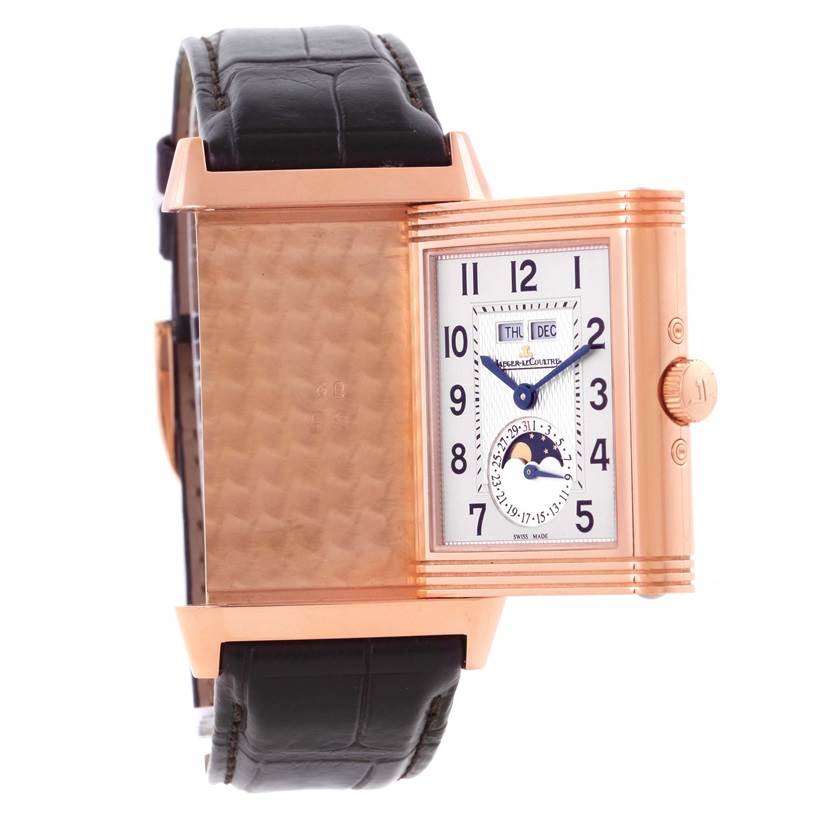 The image shows a Jaeger LeCoultre Reverso Q3752520 Men's Rose Gold Silver Dial Q3752520 Men's Rose Gold Silver Dial watch with its reversible case half-open, revealing the dial and strap.