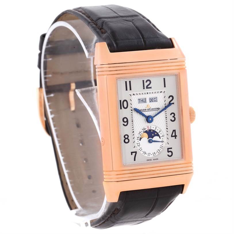 The image shows a Jaeger-LeCoultre Reverso watch from an oblique angle, displaying the face, strap, and side crown.