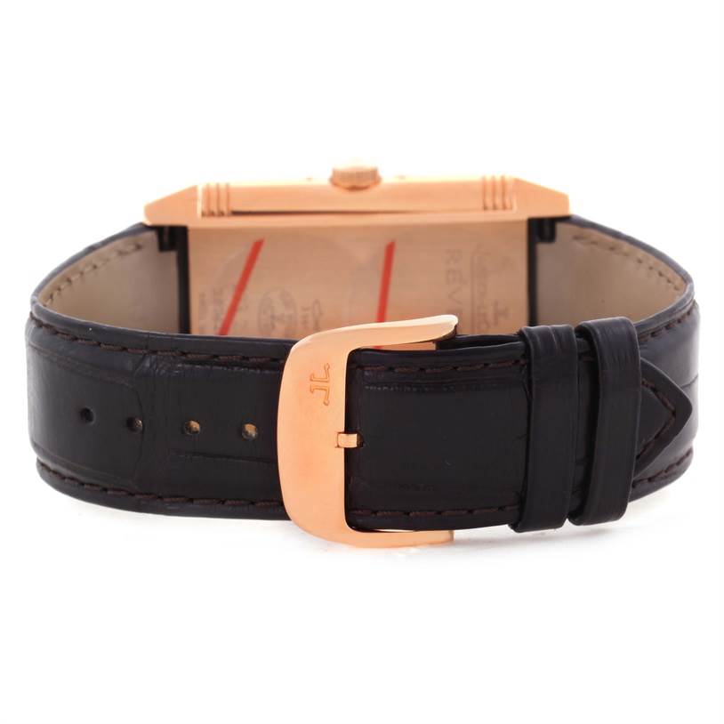This image shows the Reverso model by Jaeger LeCoultre from the rear angle, focusing on the brown leather strap and gold clasp.