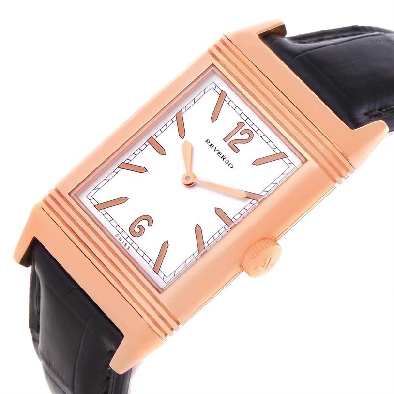 The image shows an angled view of the Jaeger-LeCoultre Reverso watch's face, crown, and leather strap.