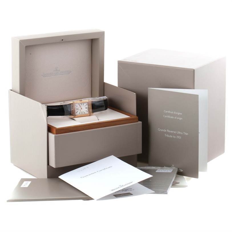 The image displays a Jaeger LeCoultre Reverso Q2782521 Men's Rose Gold White Dial Q2782521 Men's Rose Gold White Dial watch with its original packaging, box, and accompanying documentation.