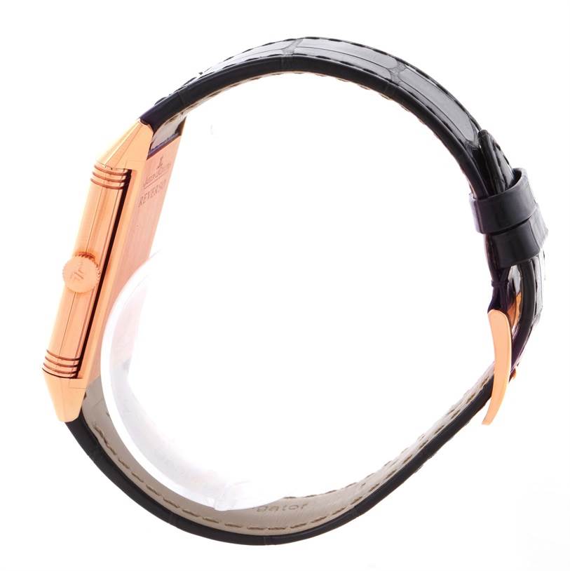 The image shows a side view of a Jaeger LeCoultre Reverso Q2782520 Men's Rose Gold Silver Dial Q2782520 Men's Rose Gold Silver Dial watch, highlighting its crown, case, and straps.