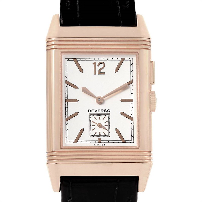 The image shows a front view of the Jaeger LeCoultre Reverso watch, displaying its rectangular dial and hands, with part of the strap visible.