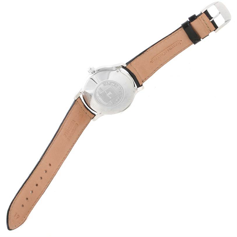 The image shows the back case and leather strap of a Jaeger-LeCoultre Master model watch from a top-down angle.