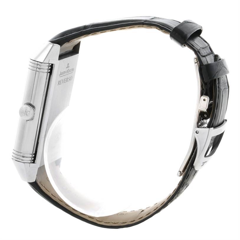 The image shows a side view of a Jaeger-LeCoultre Reverso watch, highlighting its case, side crown, and black leather strap.
