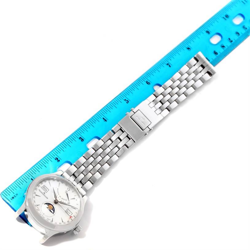 The Jaeger-LeCoultre Master model watch is shown laid flat with its face and metal bracelet aligned next to a ruler.