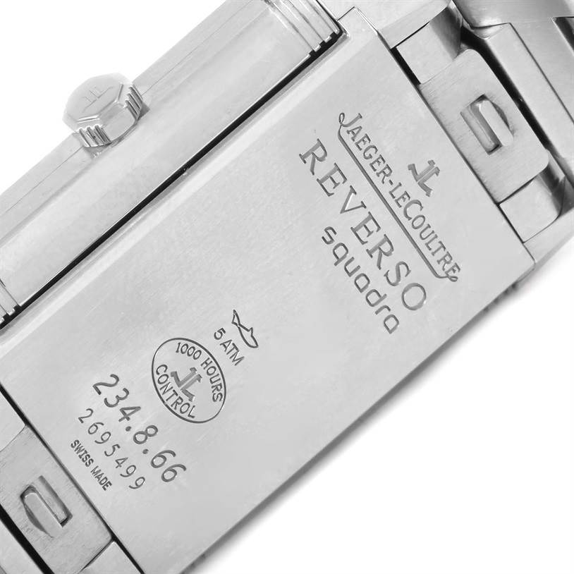 This close-up image shows the side and back of a Jaeger-LeCoultre Reverso watch, highlighting its engravings and crown.