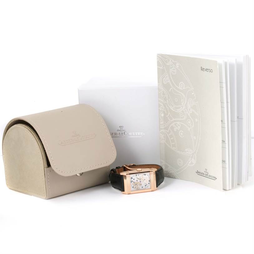 The image shows a Jaeger LeCoultre Reverso Q3042420 Men's Rose Gold Silver Dial Q3042420 Men's Rose Gold Silver Dial watch with its case back displayed, along with its box, case, and manual.