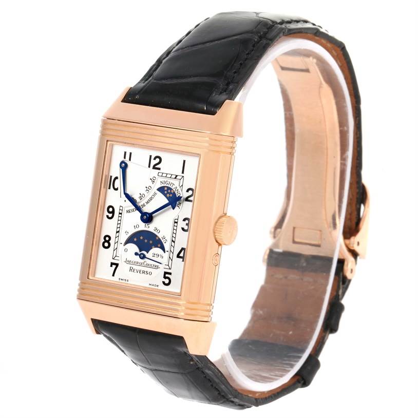 The image shows a Jaeger-LeCoultre Reverso watch at an angle highlighting the rectangular face, crown, and black leather strap.