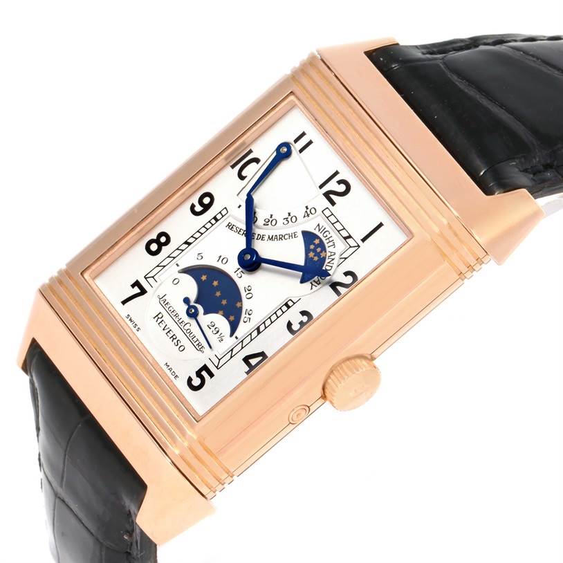 The Jaeger LeCoultre Reverso Q3042420 Men's Rose Gold Silver Dial Q3042420 Men's Rose Gold Silver Dial watch is shown at a tilted angle, highlighting its dial, crown, and black leather strap.