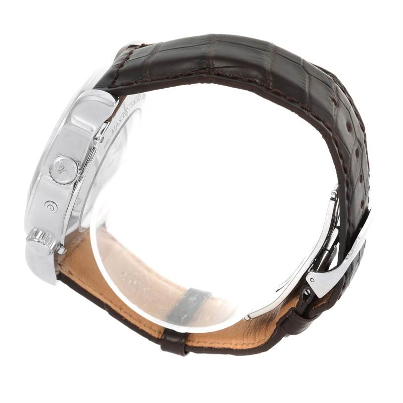 The image shows a side view of a Jaeger LeCoultre Master Q1528420 Men's Stainless Steel Silver Dial Q1528420 Men's Stainless Steel Silver Dial model watch, highlighting the case, crown, and brown leather strap.