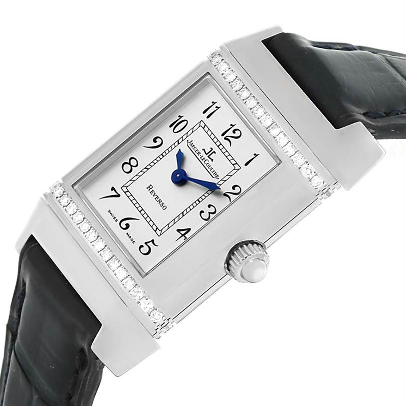 The image shows a close-up of the Jaeger-LeCoultre Reverso watch from a side angle, highlighting the dial, crown, and part of the strap.