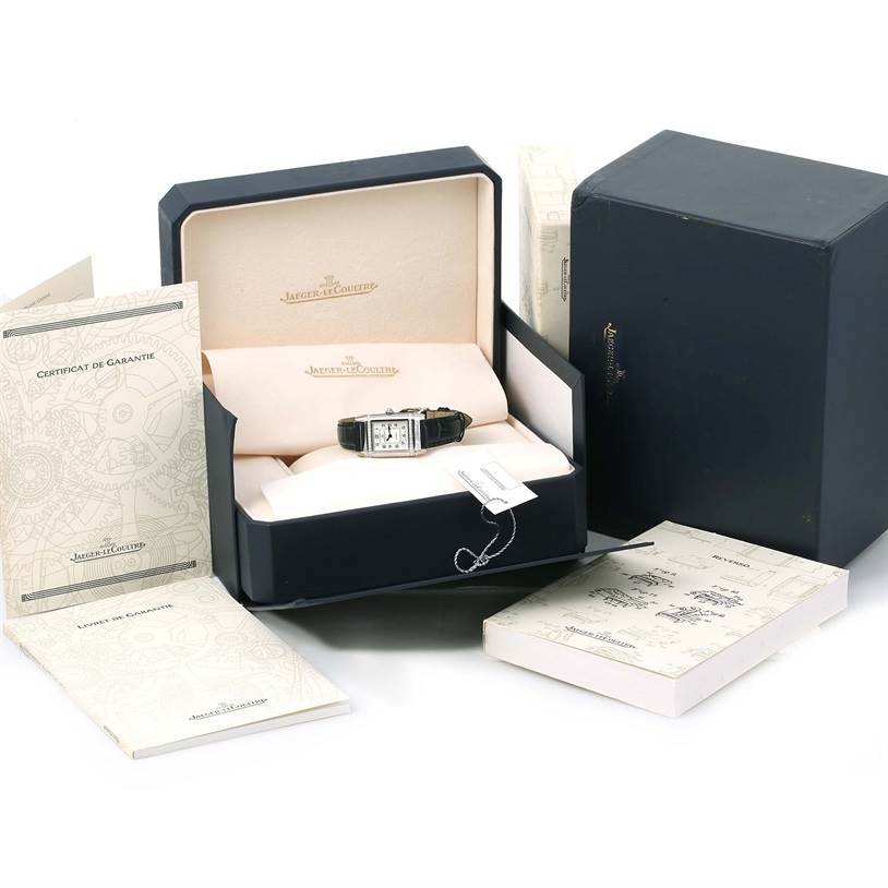 The image shows a Jaeger LeCoultre Reverso 265.8.08 Women's Stainless Steel Silver Dial 265.8.08 Women's Stainless Steel Silver Dial model watch in its open box, alongside the exterior box and documentation.