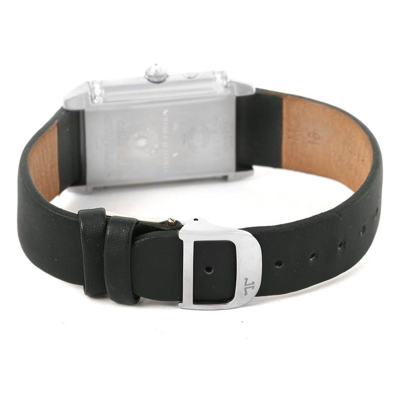 The image shows the back view of a Jaeger LeCoultre Reverso 278.2.54 Women's White Gold Silver Dial 278.2.54 Women's White Gold Silver Dial watch with a black strap and a buckle.