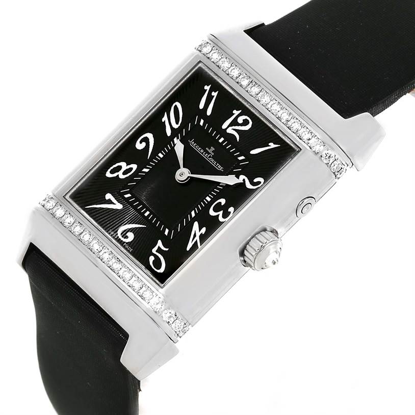 This image shows a Jaeger-LeCoultre Reverso watch at an angle, highlighting its rectangular face, crown, strap, and diamond accents.