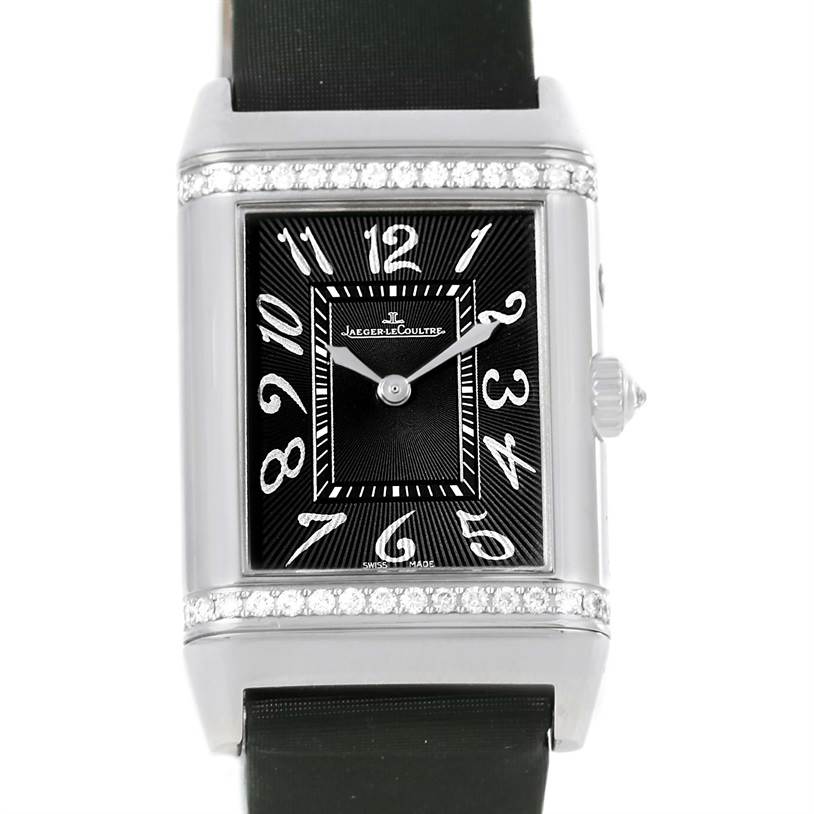 This image shows a front view of a Jaeger-LeCoultre Reverso watch, featuring its black dial, silver numerals, rectangular case, and crown.
