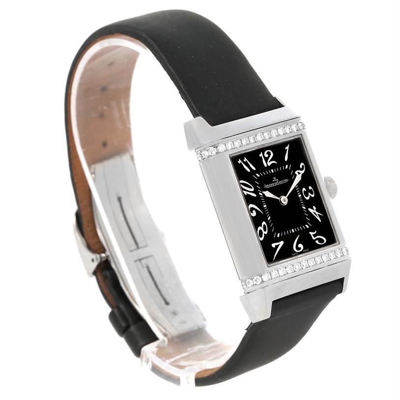 The image shows a Jaeger LeCoultre Reverso 278.2.54 Women's White Gold Silver Dial 278.2.54 Women's White Gold Silver Dial watch from an angled side view, highlighting the case, dial, strap, and bezel.