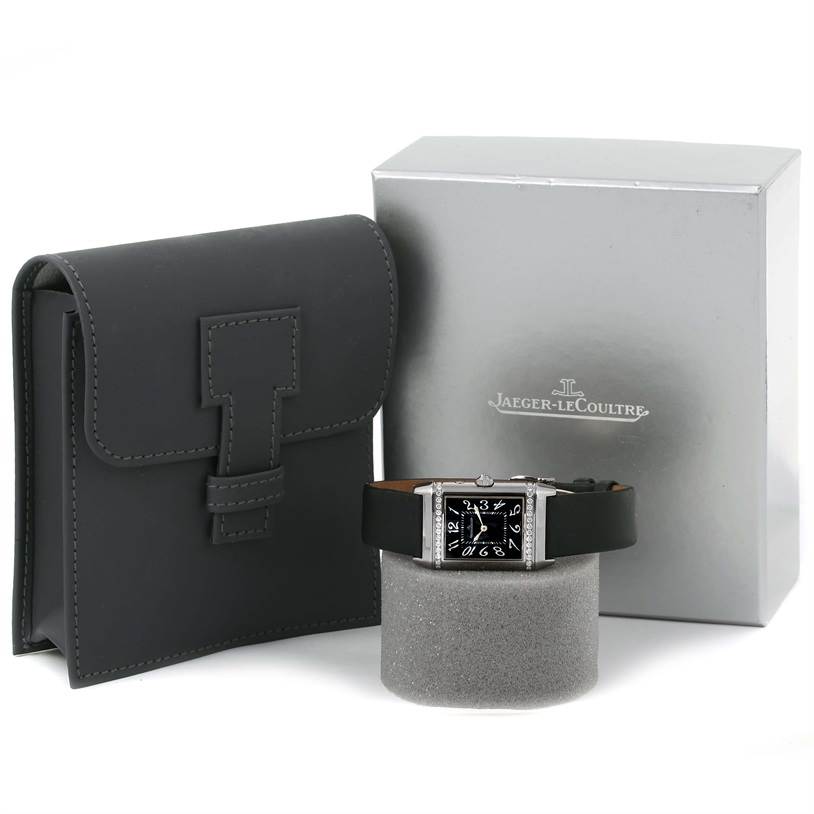 This image shows a Jaeger-LeCoultre Reverso watch with its box and a travel case.