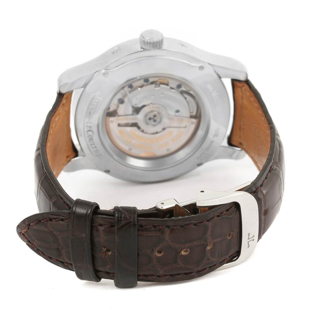 The image shows the back view of a Jaeger-LeCoultre Master model watch, highlighting the movement and leather strap with a clasp.