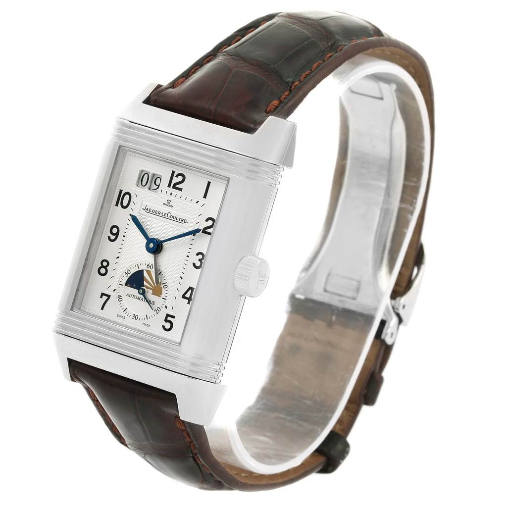 The Jaeger-LeCoultre Reverso watch is shown at an angle highlighting the front face, crown, and leather strap.