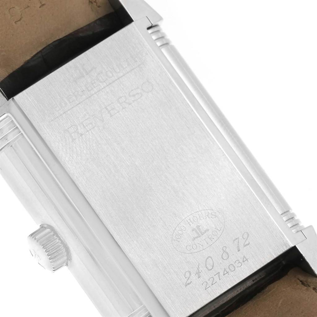 The image shows the back of the Jaeger LeCoultre Reverso 240.8.72 Men's Stainless Steel Silver Dial 240.8.72 Men's Stainless Steel Silver Dial watch with visible inscriptions and a portion of the crown.