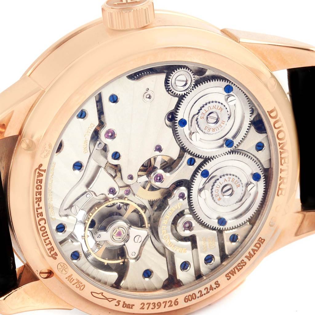 The image shows the back view of a Jaeger LeCoultre Duometre 15917 Men's Rose Gold Silver Dial 15917 Men's Rose Gold Silver Dial, revealing its intricate mechanical movement and inner gears.