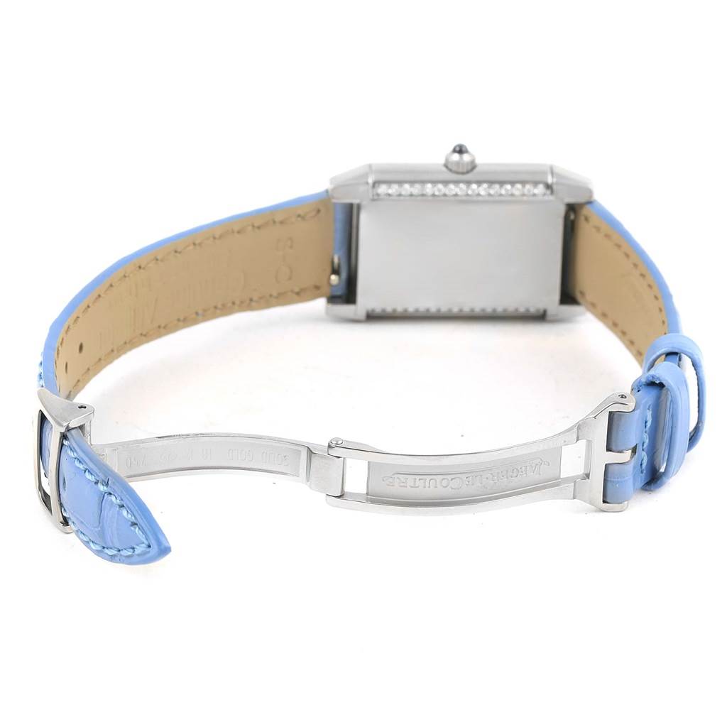 This image shows the back of the Jaeger LeCoultre Reverso Q2623402 Women's White Gold Mother of Pearl Dial Q2623402 Women's White Gold Mother of Pearl Dial watch and its blue leather strap with the clasp open.