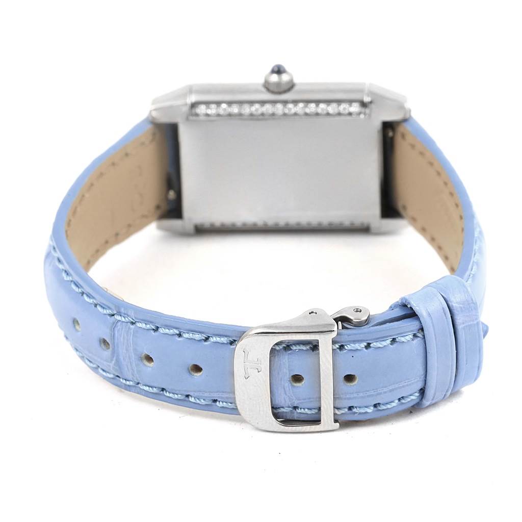 The image shows the back view of a Jaeger-LeCoultre Reverso watch with a blue leather strap and a buckle.