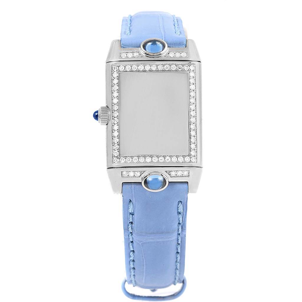 The image shows a front view of a Jaeger LeCoultre Reverso Q2623402 Women's White Gold Mother of Pearl Dial Q2623402 Women's White Gold Mother of Pearl Dial watch with a blue strap and a diamond-encrusted bezel.