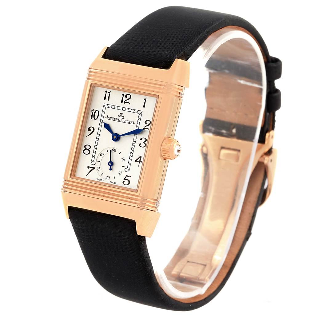 The Jaeger LeCoultre Reverso Q2562402 Women
s Rose Gold Silver Dial Q2562402 Women
s Rose Gold Silver Dial watch is shown at a slight angled view, displaying its rectangular face, crown, and black strap.