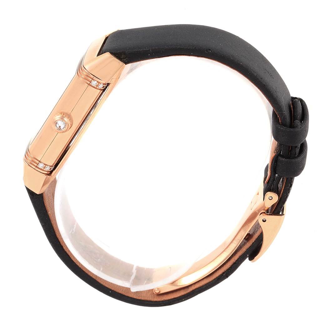 The image shows a side view of a Jaeger LeCoultre Reverso Q2562402 Women
s Rose Gold Silver Dial Q2562402 Women
s Rose Gold Silver Dial watch, highlighting its rose gold case and black strap.