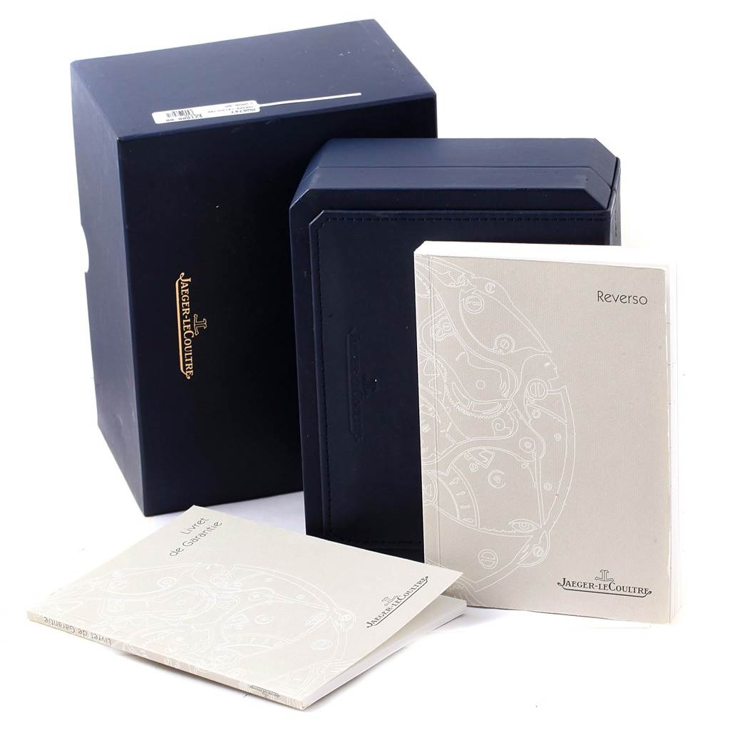 The image shows the packaging and manuals for the Jaeger LeCoultre Reverso Q2562402 Women
s Rose Gold Silver Dial Q2562402 Women
s Rose Gold Silver Dial model, including the outer box, inner case, and booklets.