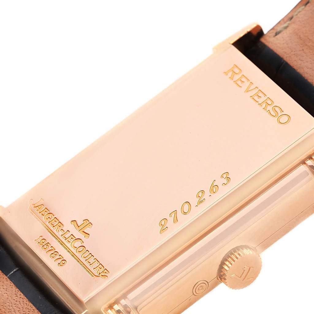 The image shows the back of a Jaeger-LeCoultre Reverso watch, highlighting the case back, model number, and the crown.