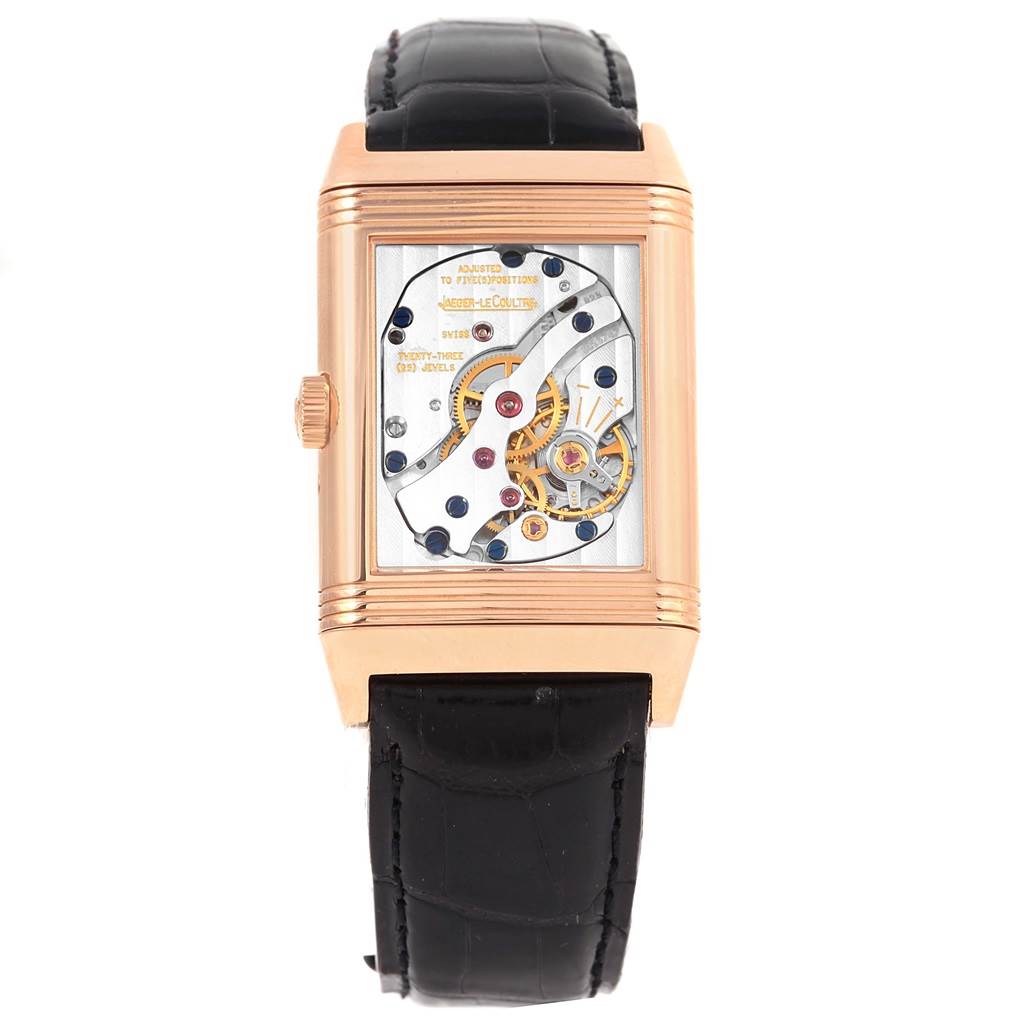 The image shows the back angle of the Jaeger-LeCoultre Reverso watch, highlighting the internal mechanical movement.