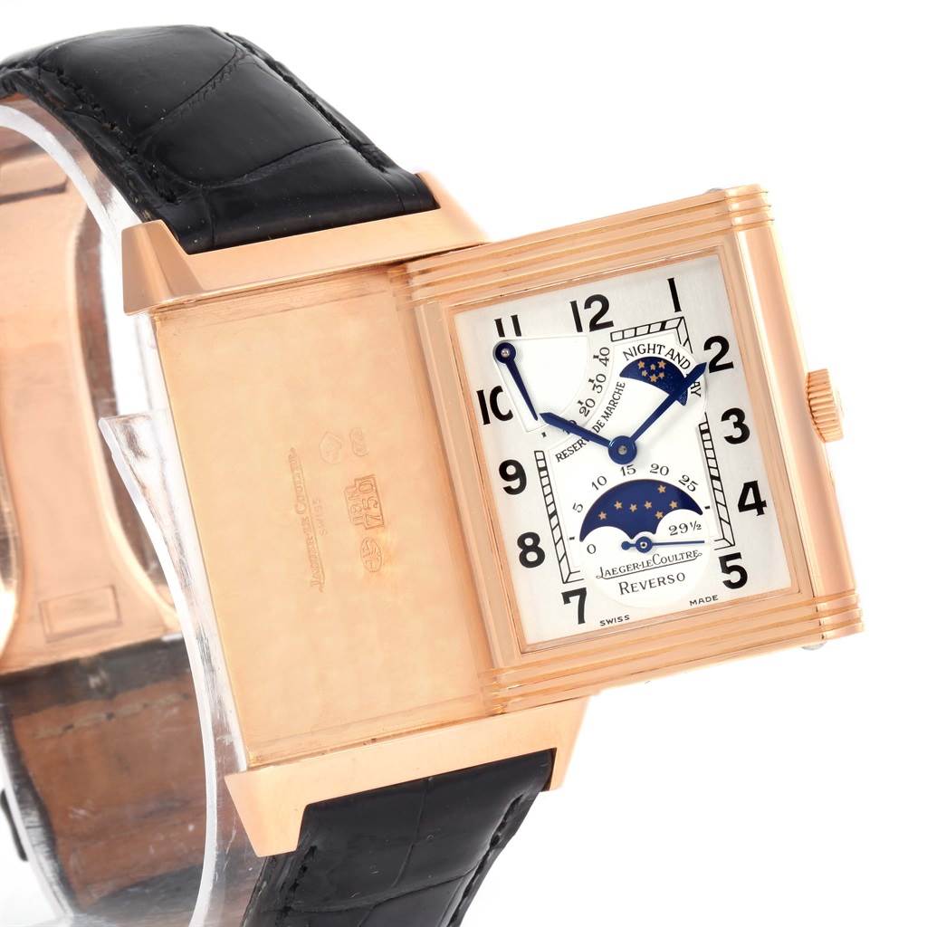 The image shows a Jaeger LeCoultre Reverso Q3042420 Men's Rose Gold Silver Dial Q3042420 Men's Rose Gold Silver Dial watch with its case swiveled to expose the back and the dial.