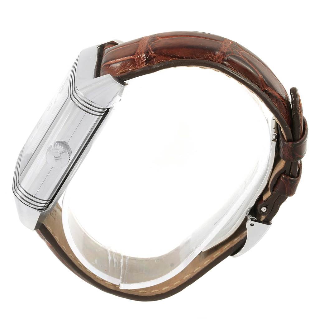 The image shows a side view of the Jaeger-LeCoultre Reverso watch, highlighting its case, crown, and leather strap.