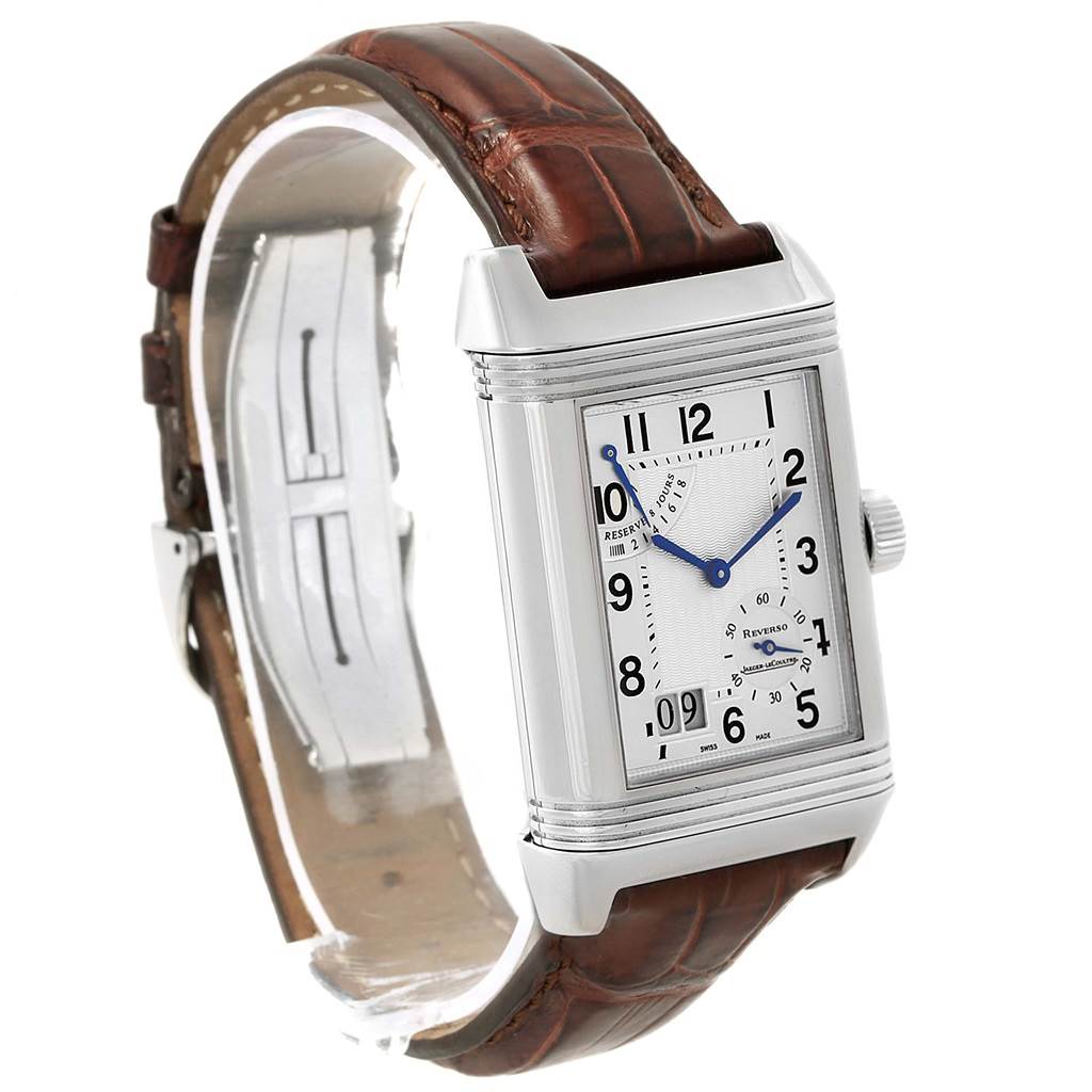The image shows a Jaeger-LeCoultre Reverso watch viewed from an angle that displays its face, brown leather strap, and stainless steel case.