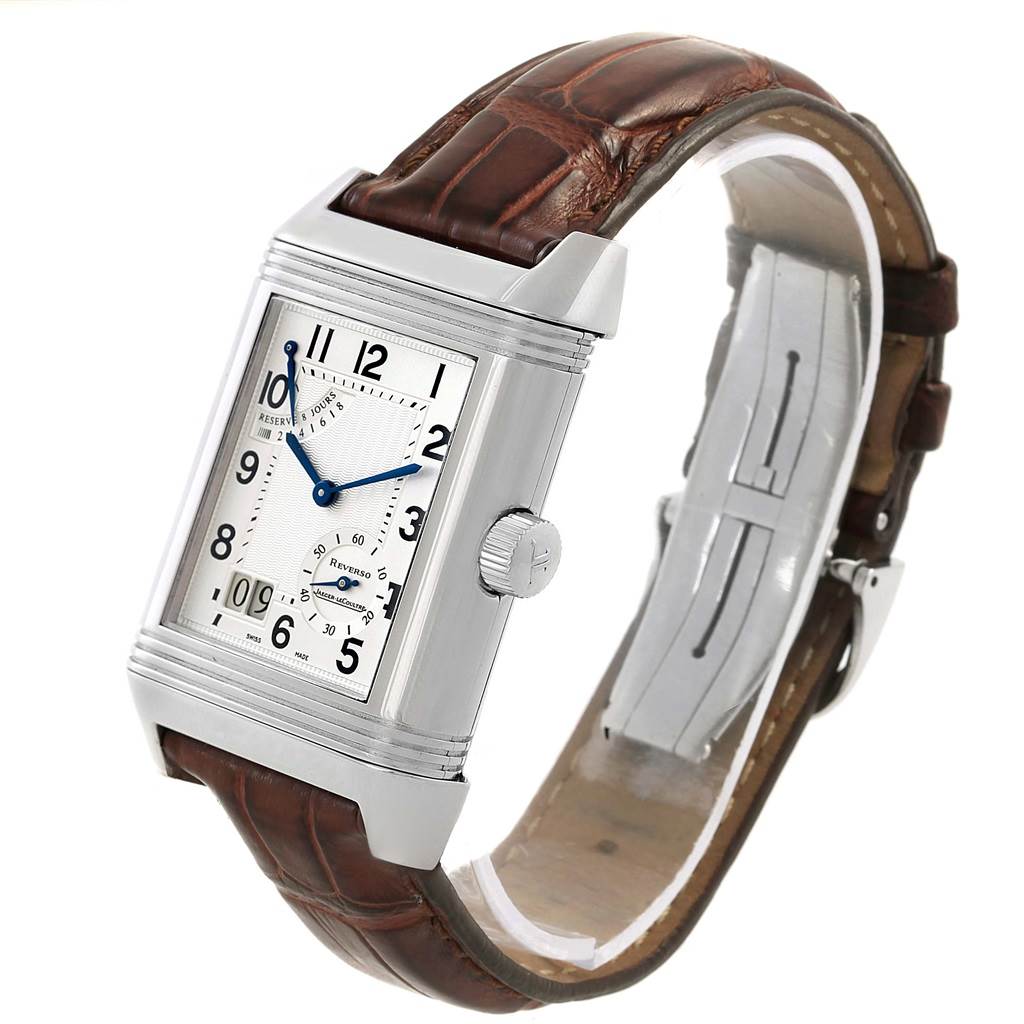 The image shows a Jaeger LeCoultre Reverso 240.8.15 Men's Stainless Steel Silver Dial 240.8.15 Men's Stainless Steel Silver Dial watch at an angle displaying its dial, brown leather strap, and side crown.